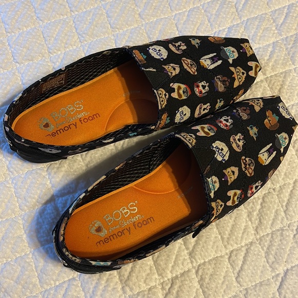 BOBS By Skechers slip on shoes in black with various dog designs on the shoes. - Picture 4 of 8